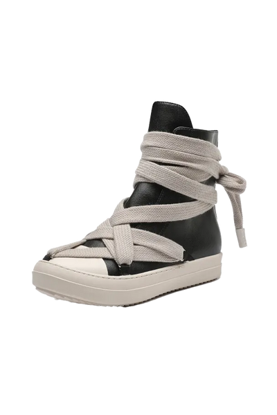 A high-top platform sneaker featuring a black leather upper wrapped with wide, light beige canvas straps that wrap around the ankle and foot, set against a plain white background.