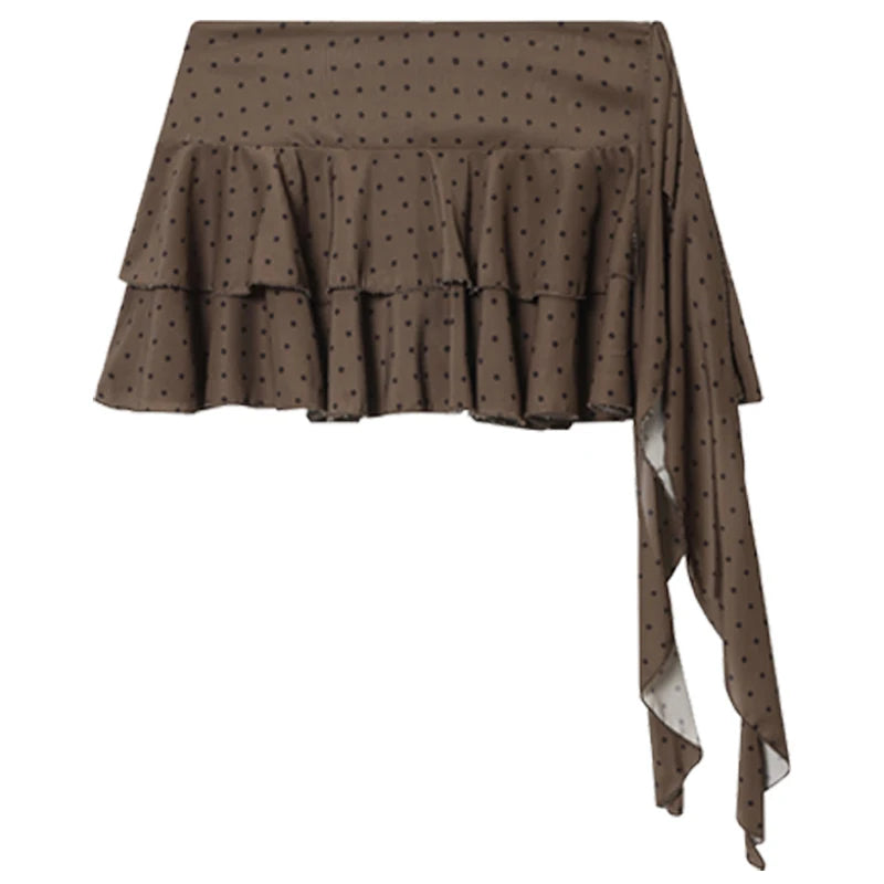 A brown ruffled skirt with a small black polka dot pattern and an asymmetrical draped side, shown against a plain white background.