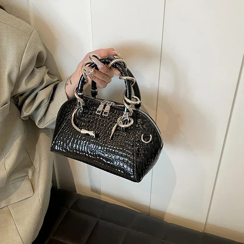 Bolso de mano con patrón de cocodrilo y forma de serpiente