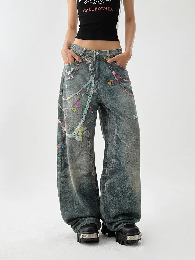 A women wearing indie aesthetic chains graffiti straight leg high waisted jeans.