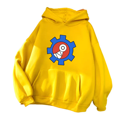 Yellow hoodie with a colorful gear design on a gray surface with books and shoes.