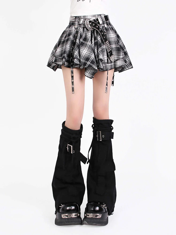 Black and white plaid skirt with black knee-high boots on a white background