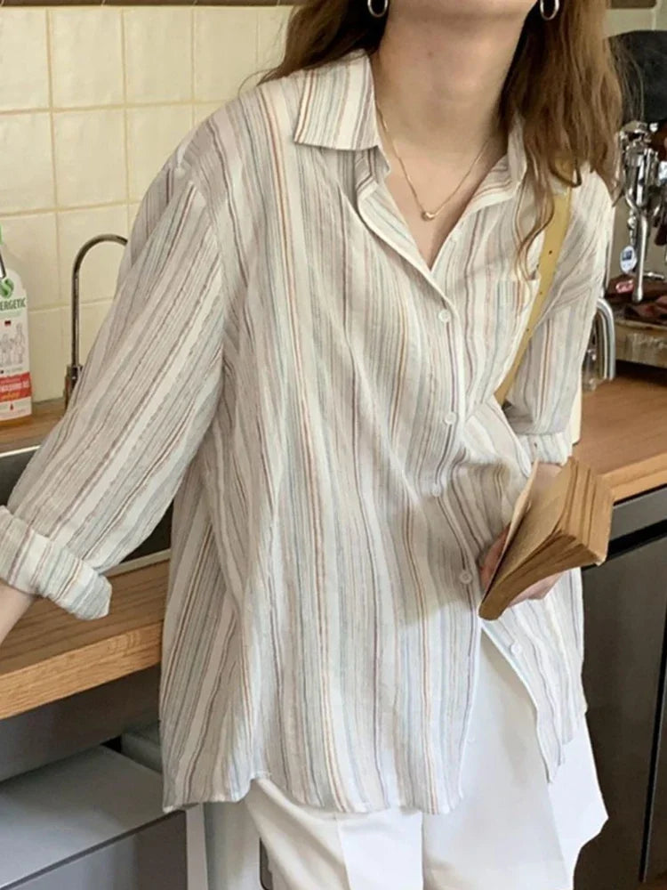 Person wearing a striped shirt in a kitchen setting