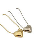 Gold and silver heart-shaped pendants on necklaces against a white background
