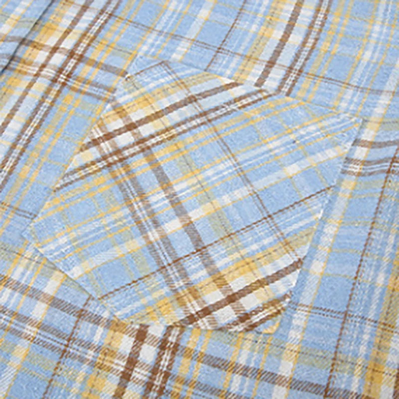 Close-up of a fabric with blue, yellow, and brown plaid pattern