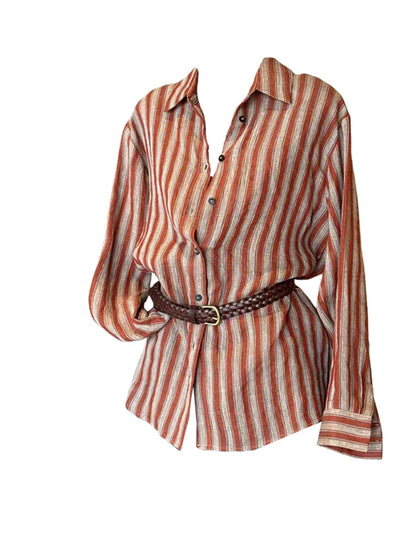 A long-sleeve button-up shirt with vertical rust-orange, beige, and brown stripes, styled with a dark brown braided belt on a white background with a fashion magazine layout on the left.