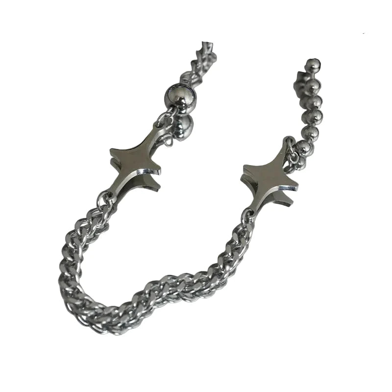 Silver bracelet with star-shaped ends on a reflective surface
