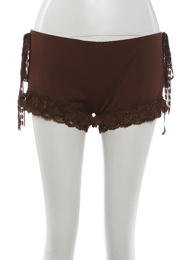 Brown lace-trimmed shorts on a white mannequin against a white background