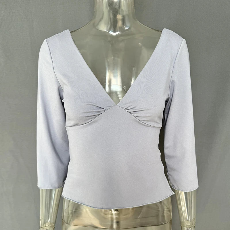 Light gray long-sleeve top on a mannequin against a gray background