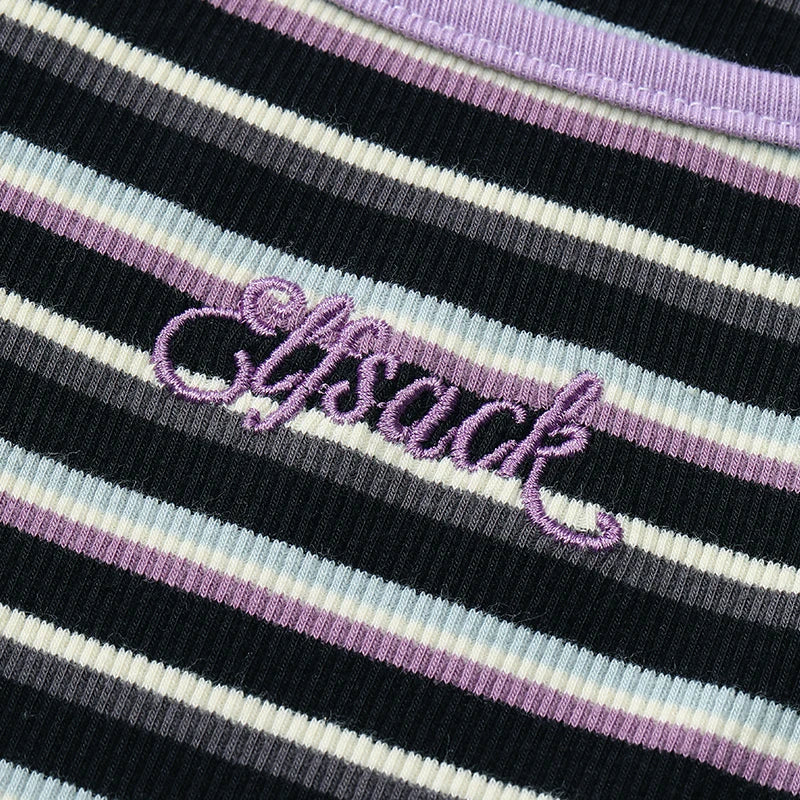 Close-up of a striped ribbed knit garment with black, white, light blue, and lavender stripes, featuring the word 'lysack' embroidered in lavender script across the chest.