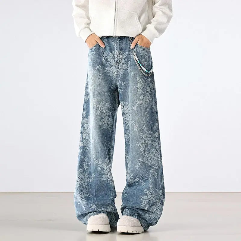 Person wearing light blue floral-patterned jeans on a white background