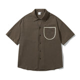 Camisa de algodón de manga corta con bolsillo delantero suelto