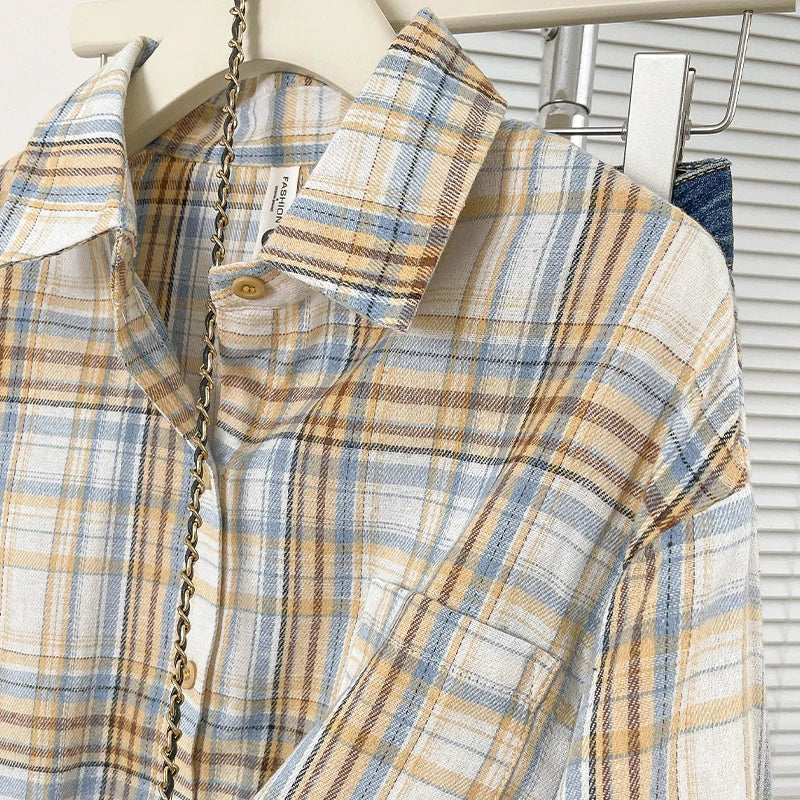 Plaid shirt on a hanger with a blurred background
