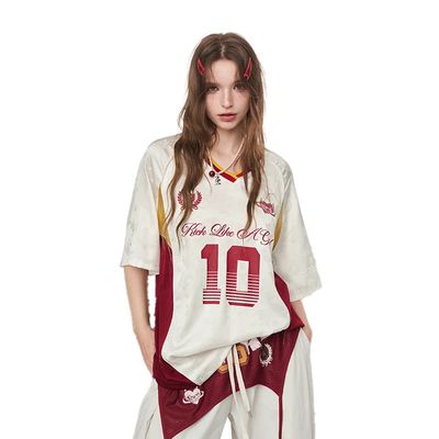 A model wearing a white and maroon basketball jersey t-shirt with 'Fast Lane NYC' and the number '10' printed on the front, paired with matching maroon and white pants, against a plain white background.
