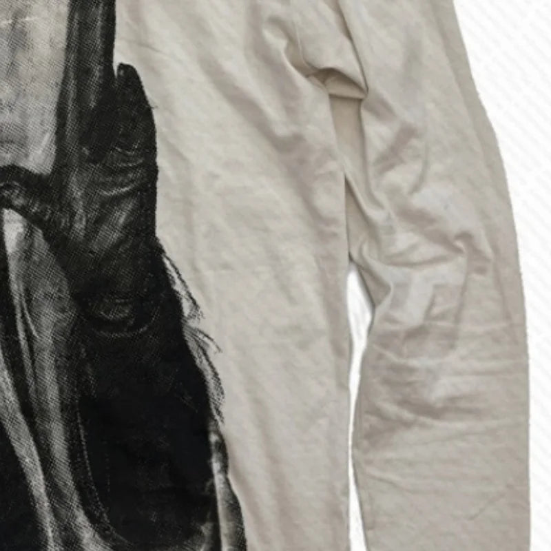Close-up of a black leather glove and beige fabric on a white background