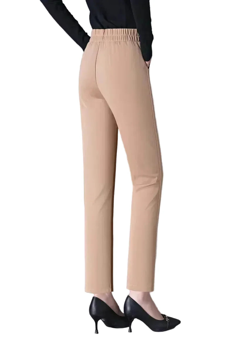Beige pants worn by a person on a gray background
