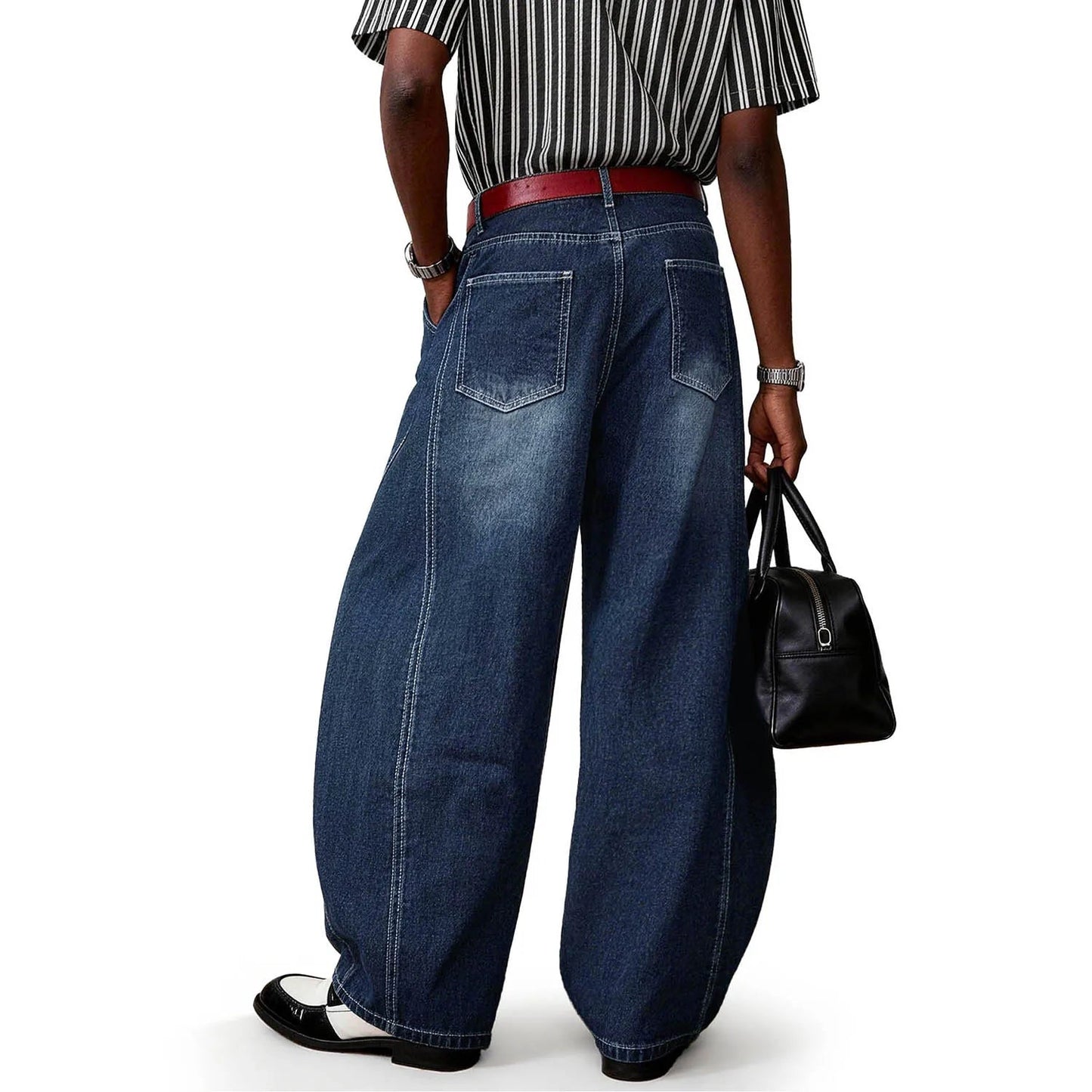 Back view of a person wearing blue splicing ultra baggy wide leg jeans.
