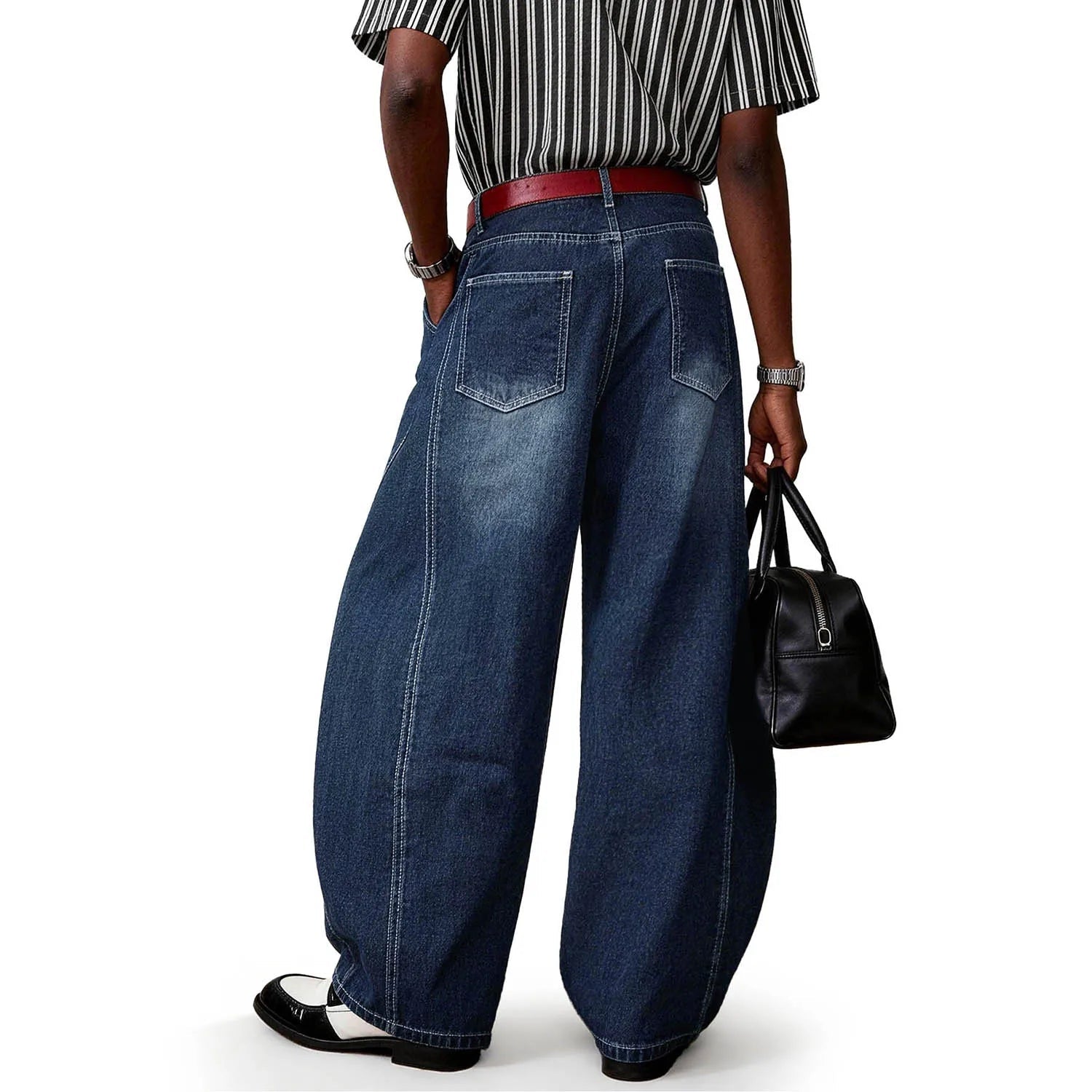 Back view of a person wearing blue splicing ultra baggy wide leg jeans.