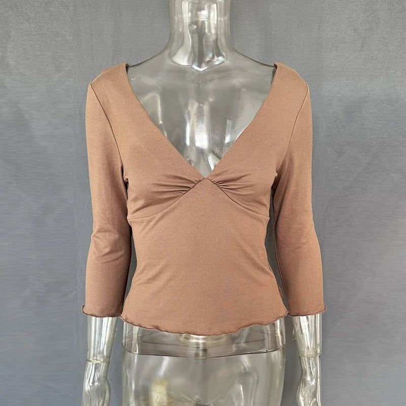 Brown long-sleeve top on a mannequin against a gray background