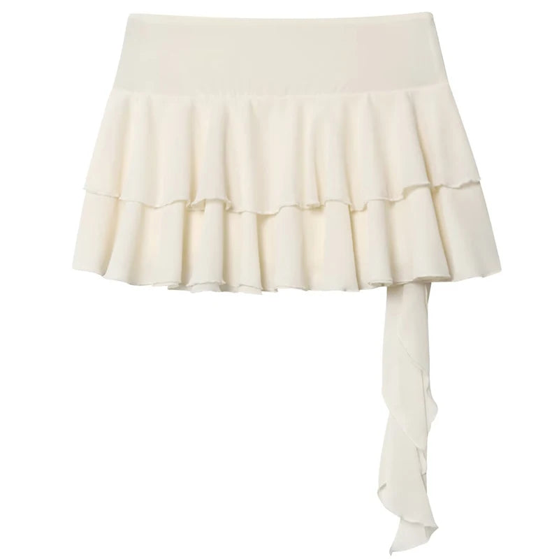 An off-white ruffled mini skirt with a wide waistband and a long side drape, shown against a plain white background.