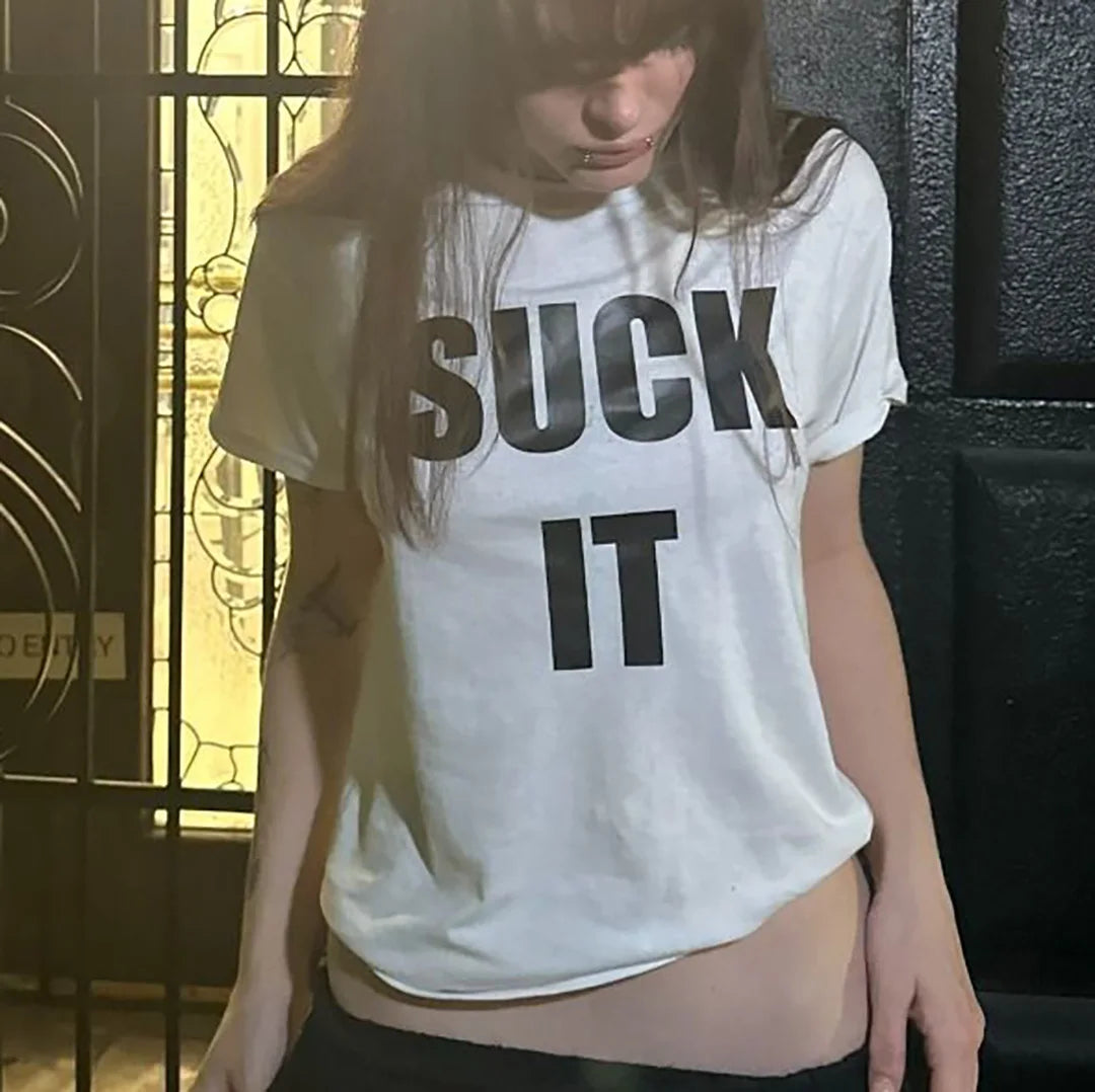 Person wearing a white t-shirt with black text in an indoor setting