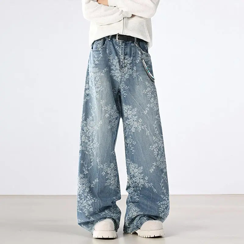 Person wearing light blue floral-patterned jeans on a white background