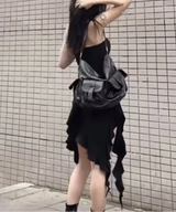 Woman holding a black and gray bag against a tiled wall, with 'SylCue' branding.