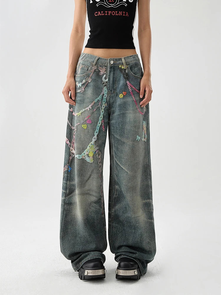 A women wearing indie aesthetic chains graffiti straight leg high waisted jeans.