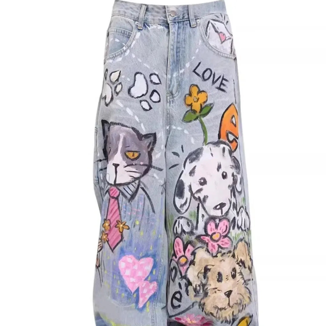Denim pants with hand-painted designs of animals and hearts on a white background