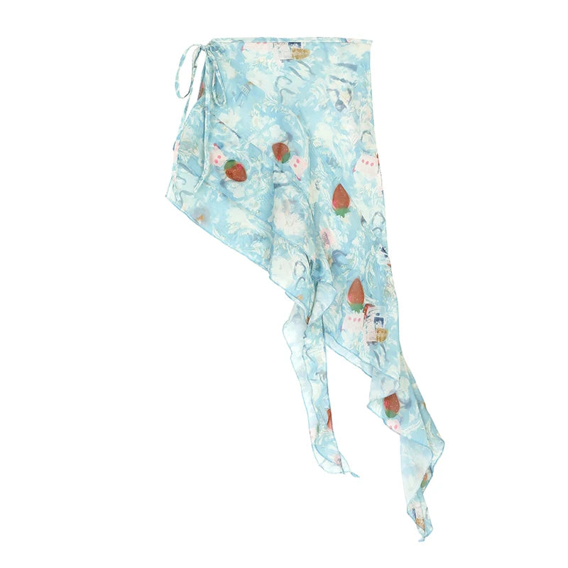 A light blue chiffon scarf with a whimsical winter print featuring snowflakes, snowmen, and red berries, shown against a plain white background.