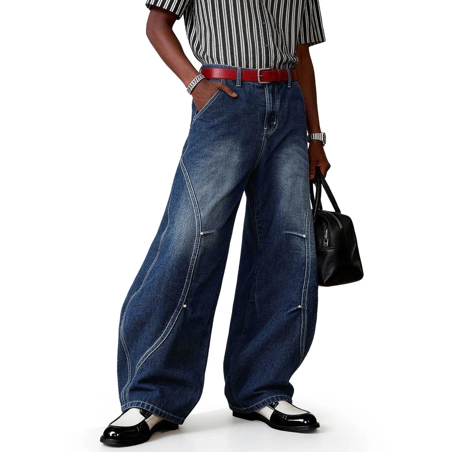 A person wearing blue splicing ultra baggy wide leg jeans.