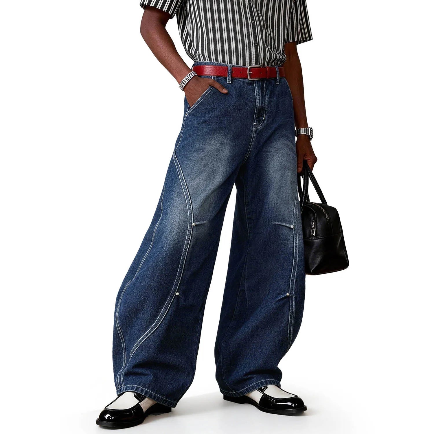 A person wearing blue splicing ultra baggy wide leg jeans.