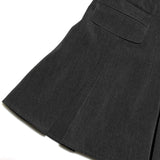 Close-up of a dark gray skirt with a pocket on a white background