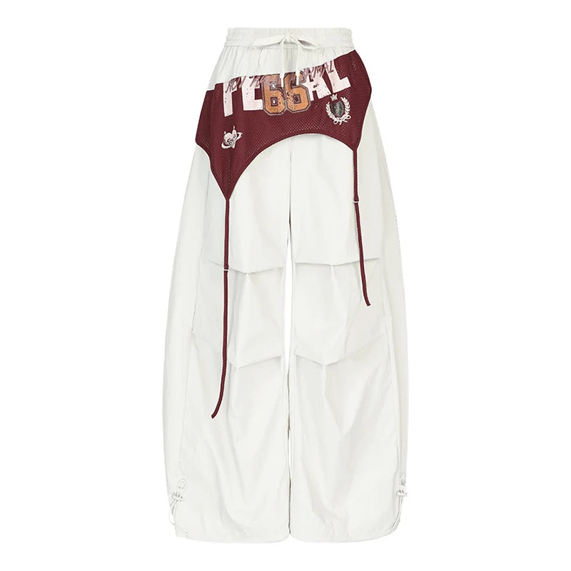 White wide-leg cargo pants with a maroon contrast waistband and upper leg panels, featuring 'TECH 66' text and small graphic details, shown on a plain white background.