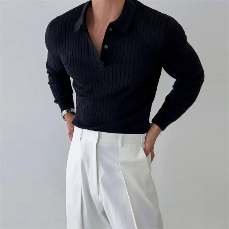 Person wearing a black ribbed sweater and white pants on a gray background