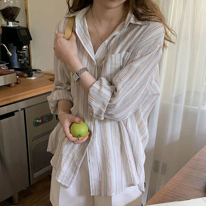 Person holding a green apple in a kitchen setting