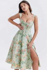 Woman wearing a floral dress with a slit on a white background