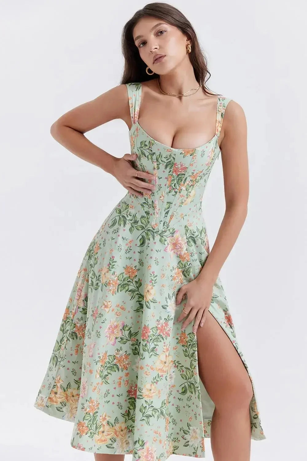 Woman wearing a floral dress with a slit on a white background